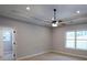 Spacious bedroom with large windows, tray ceiling, ceiling fan, and neutral carpet at 2117 Hwy 101 N, Dallas, GA 30157