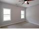Bedroom with natural light, neutral paint and carpet, and a modern ceiling fan fixture at 2117 Hwy 101 N, Dallas, GA 30157