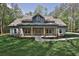 Charming home with a welcoming front porch featuring stone accents and sturdy wooden support columns at 2117 Hwy 101 N, Dallas, GA 30157