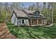 Charming home with a welcoming front porch featuring stone accents and sturdy wooden support columns at 2117 Hwy 101 N, Dallas, GA 30157