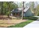 Charming home with a welcoming front porch featuring stone accents and sturdy wooden support columns at 2117 Hwy 101 N, Dallas, GA 30157