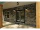 Inviting front porch with stone facade, timber supports, and stylish double door entrance at 2117 Hwy 101 N, Dallas, GA 30157