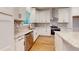 Well-lit kitchen with stainless steel dishwasher, white cabinets and stunning backsplash at 2117 Hwy 101 N, Dallas, GA 30157