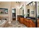 Main bathroom featuring dual vanities, a soaking tub, and elegant finishes at 3330 Chimney Point Dr, Cumming, GA 30041