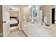 Bright bathroom featuring double sinks, marble countertops, and a decorative window at 3330 Chimney Point Dr, Cumming, GA 30041