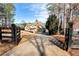 Estate home behind gated drive featuring multiple materials like stone and wood on the facade at 3330 Chimney Point Dr, Cumming, GA 30041