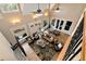 Open-concept living room with plenty of seating and natural light from large windows at 3330 Chimney Point Dr, Cumming, GA 30041