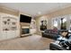 Cozy living room features a fireplace, built-in shelves, and access to the outdoor deck at 3330 Chimney Point Dr, Cumming, GA 30041