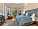 Luxurious main bedroom with a tray ceiling, large windows, and elegant decor at 3330 Chimney Point Dr, Cumming, GA 30041