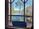 A covered porch and swing overlooks the lake and trees that surround the lakefront property at 3330 Chimney Point Dr, Cumming, GA 30041