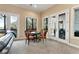 Bright sitting area with a table set and natural light from the windows and French doors at 3330 Chimney Point Dr, Cumming, GA 30041