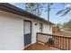 Relaxing outdoor space on the wood deck of a beautifully renovated white brick home at 365 Cowan Rd, Covington, GA 30016