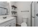 Clean bathroom featuring a glass-enclosed shower, floating shelves, and a modern vanity at 365 Cowan Rd, Covington, GA 30016