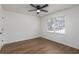 Neutral bedroom with hardwood floors, ceiling fan, a window with blinds, and a closet at 365 Cowan Rd, Covington, GA 30016