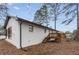 White-painted brick home features a new roof, a charming porch, and a wooden deck at 365 Cowan Rd, Covington, GA 30016