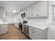 Well-lit kitchen equipped with stainless steel appliances, white cabinets, and sleek countertops at 365 Cowan Rd, Covington, GA 30016