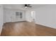 Bright living room with hardwood flooring, a ceiling fan, and ample natural light at 365 Cowan Rd, Covington, GA 30016