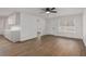 Open-concept living room with hardwood flooring, ceiling fan, and an abundance of natural light at 365 Cowan Rd, Covington, GA 30016