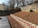 Multi-tiered backyard featuring a retaining wall, landscape, and a wooden fence at 430 Citronelle Dr, Woodstock, GA 30188