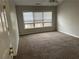 Bright bedroom with neutral walls, plush carpet, and a window providing ample natural light at 430 Citronelle Dr, Woodstock, GA 30188