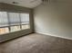 Bright bedroom featuring a ceiling fan, large window, neutral walls and plush carpet at 430 Citronelle Dr, Woodstock, GA 30188