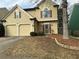 Charming home featuring a two-car garage, manicured landscaping, and a welcoming entrance at 430 Citronelle Dr, Woodstock, GA 30188