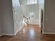 Inviting foyer with hardwood floors, white trim, and staircase with wood handrail at 430 Citronelle Dr, Woodstock, GA 30188