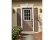 Close-up of a front door with sidelights, traditional hardware, and a secure smart lock at 430 Citronelle Dr, Woodstock, GA 30188