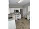 Well-lit kitchen with white cabinetry, updated countertops, and stainless steel appliances at 430 Citronelle Dr, Woodstock, GA 30188