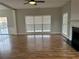 Open-concept living room with gleaming hardwood floors, fireplace, and sliding glass doors at 430 Citronelle Dr, Woodstock, GA 30188