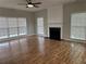 Spacious living room with fireplace, large windows allowing ample natural light, and ceiling fan at 430 Citronelle Dr, Woodstock, GA 30188