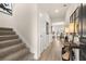 Welcoming entryway with staircase, wood-look floors, stylish decor, and access to the kitchen at 125 Maplewood Ln, Conyers, GA 30094