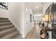 Welcoming entryway with staircase, wood-look floors, stylish decor, and access to the kitchen at 125 Maplewood Ln, Conyers, GA 30094