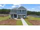 Inviting two-story home with a blue exterior, a well-manicured front yard, and a covered entry at 125 Maplewood Ln, Conyers, GA 30094