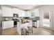 Bright kitchen features white cabinets, stainless steel appliances, granite countertops, and a stylish island with seating at 125 Maplewood Ln, Conyers, GA 30094