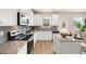 Modern kitchen boasts white cabinetry, stainless steel appliances, granite counters, and a center island with barstool seating at 125 Maplewood Ln, Conyers, GA 30094