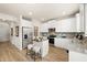 Modern kitchen featuring white cabinetry, stainless steel appliances, granite counters, and center island with barstool seating at 125 Maplewood Ln, Conyers, GA 30094