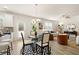 Open-concept living and dining area with stylish furnishings, wood flooring, and a modern chandelier at 125 Maplewood Ln, Conyers, GA 30094