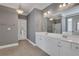 This bathroom offers a double vanity, tile floors, granite countertops, and modern fixtures at 2229 Saint Kennedy Ln, Buford, GA 30518