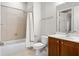 Bright bathroom features a shower over tub combination and single sink vanity with tile flooring at 2300 Peachford Rd # 3411, Atlanta, GA 30338
