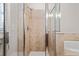 Bathroom featuring tiled shower with glass door and soaking tub at 2300 Peachford Rd # 3411, Atlanta, GA 30338