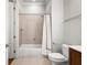 Bright bathroom features a shower over tub combination and single sink vanity with tile flooring at 2300 Peachford Rd # 3411, Atlanta, GA 30338