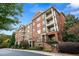 Beautiful brick condo building with balconies and landscaped grounds offering a luxurious living experience at 2300 Peachford Rd # 3411, Atlanta, GA 30338