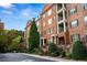 Brick building with classic architecture, featuring multiple levels with private balconies and manicured landscaping at 2300 Peachford Rd # 3411, Atlanta, GA 30338