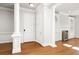 Elegant foyer showcases hardwood floors, architectural columns, and access to the living room at 2300 Peachford Rd # 3411, Atlanta, GA 30338