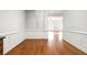 Hallway with hardwood floors and decorative molding leads to a spacious living area at 2300 Peachford Rd # 3411, Atlanta, GA 30338