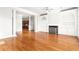 Bright living room with hardwood floors, fireplace, built-in shelving, and elegant pillars at 2300 Peachford Rd # 3411, Atlanta, GA 30338