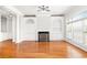 Light-filled living room with fireplace, custom built-ins, hardwood floors, and elegant architectural details at 2300 Peachford Rd # 3411, Atlanta, GA 30338