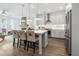 Open kitchen with island seating, stainless appliances, and seamless flow to the living area at 2320 Edgar Park Pl # 95, Duluth, GA 30096