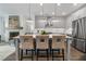 Kitchen island view with seating, stainless appliances, hardwood flooring, open to living area with fireplace at 2320 Edgar Park Pl # 95, Duluth, GA 30096